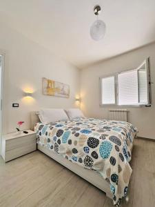 a bedroom with a bed with a comforter on it at MaurusHome come a casa tua. in Fiumicino
