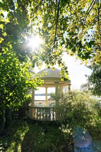 a gazebo sitting in the middle of a park at Hotel Solar Palace SPA & Wellness in Mrągowo