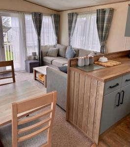 a kitchen and living room with a couch and a table at Beautiful Static Caravan Hoburne Devon Bay in Paignton