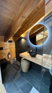 a bathroom with a sink and a mirror at ARTYSUR LUX VILLAGE CASA 2 in Sierra Nevada