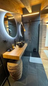 a bathroom with a sink and a mirror at ARTYSUR LUX VILLAGE CASA 2 in Sierra Nevada +18 photos