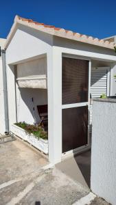 a garage with a door and a window at Bol Studio Gospojica in Bol