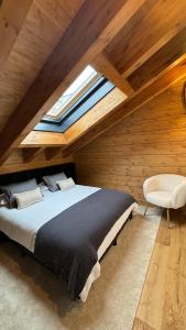 a bedroom with a large bed and a skylight at ARTYSUR LUX VILLAGE CASA 2 in Sierra Nevada