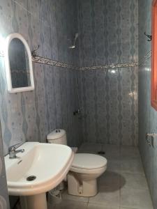 a bathroom with a toilet and a sink at Family house 2 bedrooms, 2 sdb, near Center of Nador & Airport in Selouane