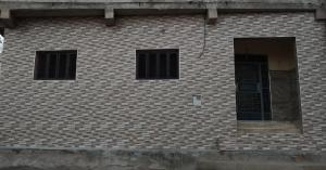 a brick building with two windows and a door at Family house 2 bedrooms, 2 sdb, near Center of Nador & Airport in Selouane