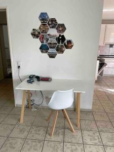 a white table and a white chair in a kitchen at Exklusives Penthouse (72qm) - mit Terrasse im Zentrum in Cologne