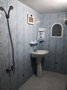 a bathroom with a sink and a shower at Family house 2 bedrooms, 2 sdb, near Center of Nador & Airport in Selouane