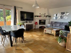 a living room with a table and a fireplace at Villa Mon Rêve in Le Cannet