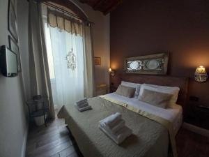 a bedroom with a bed with two towels on it at B&B Cimatori in Florence
