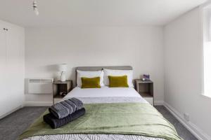 a bedroom with a large bed with two pillows on it at Modern 2-Bed Gem in Picturesque Ramsgate Central Location in Kent