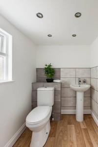 a bathroom with a toilet and a sink at Modern 2-Bed Gem in Picturesque Ramsgate Central Location in Kent