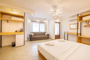 a large bedroom with a bed and a couch at Luna Kaş in Kaş