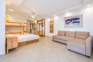 a living room with a bed and a couch at Luna Kaş in Kaş