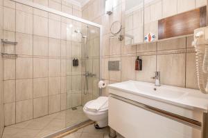 a bathroom with a toilet and a sink and a shower at Luna Kaş in Kaş