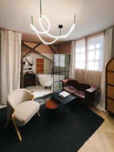 a living room with a couch and a chair at Nest in Győr
