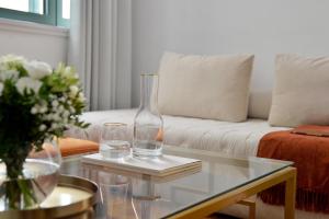 a living room with a glass table with two glasses at Athenaeum Eridanus Luxury Hotel in Athens