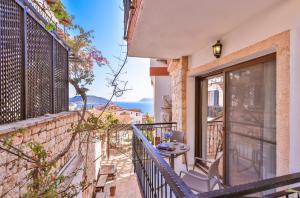 a balcony of a house with a table and chairs at Luna Kaş in Kaş