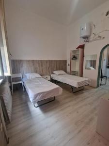 a hospital room with two beds in it at ARCOBALENO by DIMORA CHIC in Novara