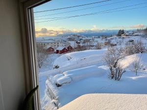 a view of a snow covered city from a window at Å, the far end of Lofoten. in Moskenes