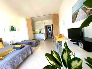 a large living room with two beds and a television at Apartment Vista Mar Piscina Albufeira in Albufeira +37 photos
