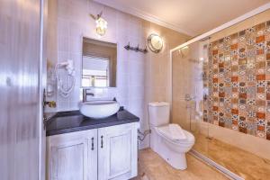 a bathroom with a toilet and a sink and a shower at Luna Kaş in Kaş