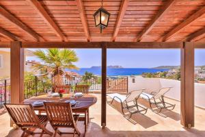 a patio with a table and chairs on a deck at Luna Kaş in Kaş