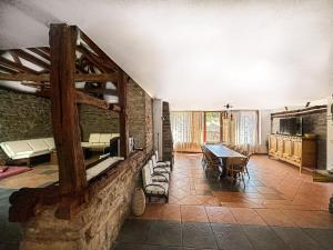 a living room with a table and a dining room at Hadjigabarevata Kashta in Dŭlbok Dol