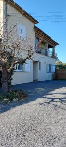 a white house with a tree in front of it at Campagno chambre d hote in Mougins