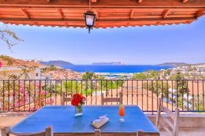 a blue table on a balcony with a view of the ocean at Luna Kaş in Kaş