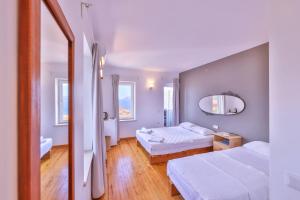 a hotel room with two beds and a mirror at Luna Kaş in Kaş