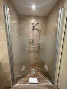 a bathroom with a shower with a towel on the floor at Hôtel Ulysse Montpellier Centre in Montpellier +37 photos