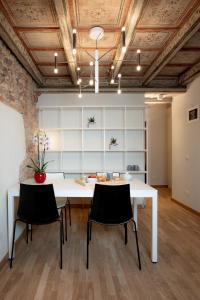 une salle à manger avec une table et des chaises blanches dans l'établissement Verona Design, à Vérone