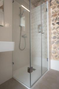 a shower with a glass door in a bathroom at Verona Design in Verona