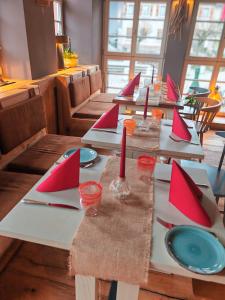 a long table with red napkins and candles on it at The Boutique Hotel Dsignio in Ladenburg
