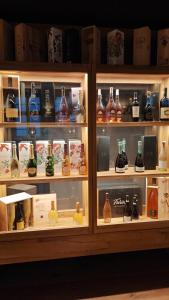a display case filled with lots of alcohol bottles at The Boutique Hotel Dsignio in Ladenburg