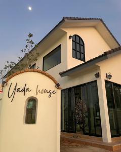 a house with a sign that reads vlore house at Yada house onsen pool villa in Ban Nong Saeng