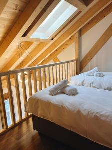 two beds in a attic room with wooden ceilings at Maison des Sports in Villars-sur-Ollon