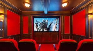 a movie room with a tv and red walls at Luxury Lodge Tinakilly in Wicklow