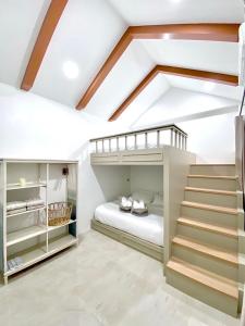 a bedroom with a loft bed and a staircase at Yada house onsen pool villa in Ban Nong Saeng