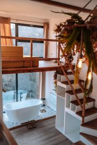 a bathroom with a large window and a white bath tub at Armonia by NorAtlas Heritage - Adults Only in Buzău