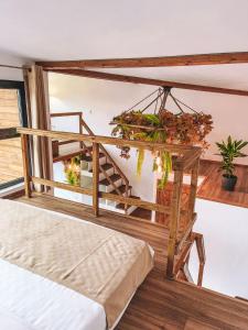 a room with a bed and some plants at Armonia by NorAtlas Heritage - Adults Only in Buzău