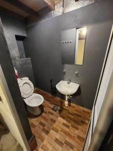 a bathroom with a toilet and a sink at Dou Houz Georgetown in George Town
