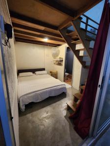 a bedroom with a white bed and a staircase at Dou Houz Georgetown in George Town