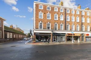 a large brick building on a city street at WhiskAwayStays - Victoria House - Apartment 4 in Worcester
