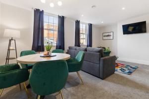 a living room with a couch and a table and chairs at WhiskAwayStays - Victoria House - Apartment 4 in Worcester