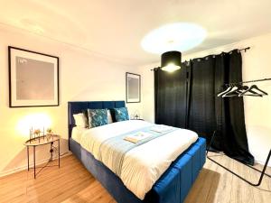a bedroom with a large bed with a black curtain at Rooms Near Me - Worcester, Sky Tv, Free Double Parking in Worcester