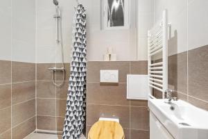 a bathroom with a shower and a toilet and a sink at City Center Suite - Modern & Stylish in Bratislava