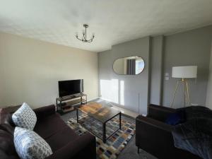 a living room with a couch and a table at Stunning 3 bedrooms house with Garden and Free Parking in Barnsley