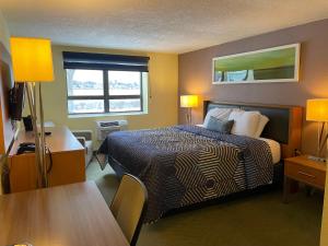 a hotel room with a bed and a table at Lakeside Inn in Wakefield +57 photos