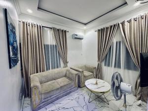a living room with a couch and a table at Oreo by PartyTown in Ankuru